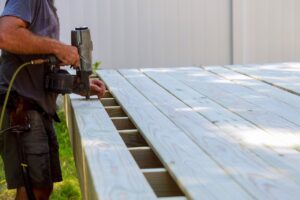 contractor bolting down deck boards.