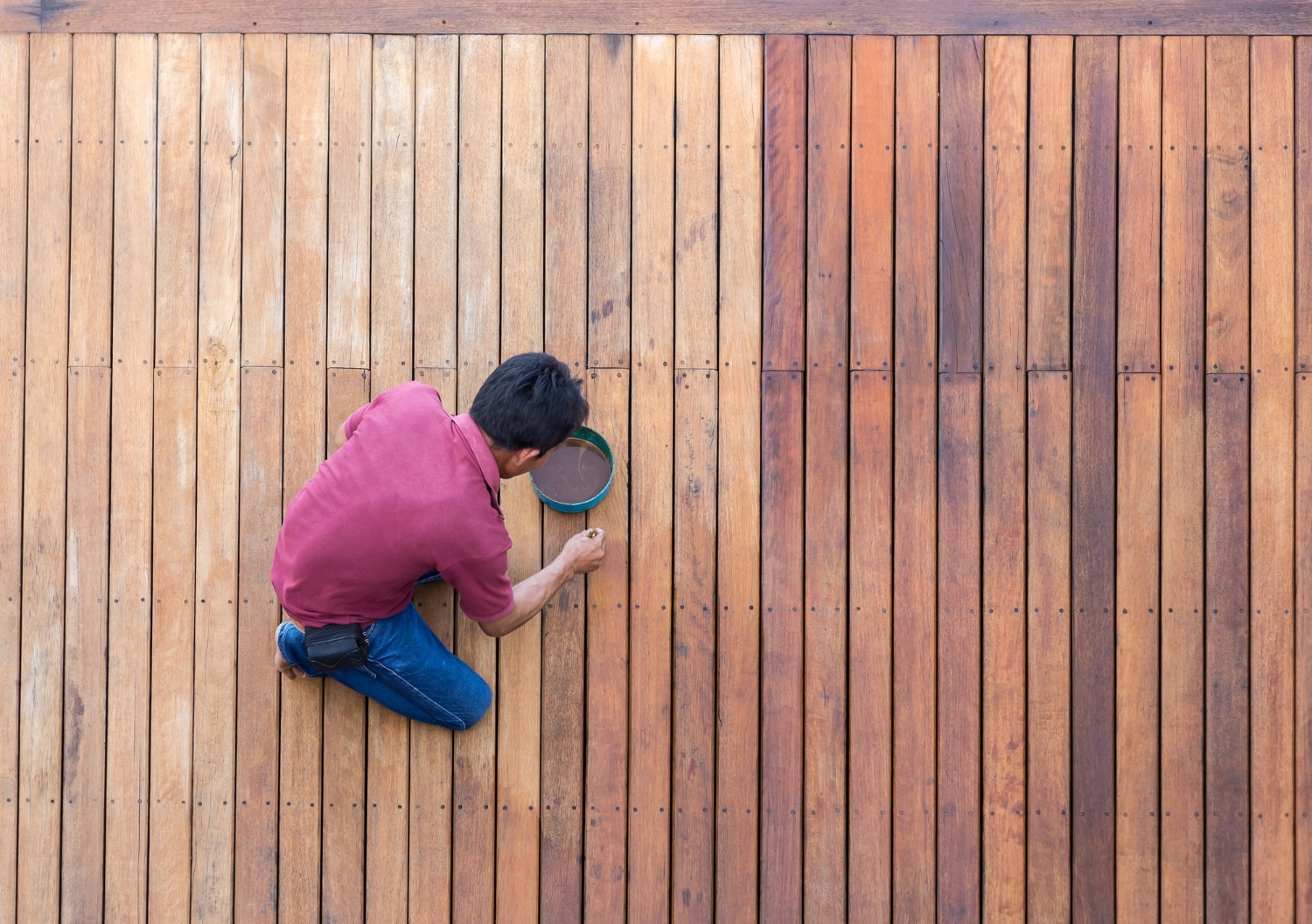 Contractor staining an outdoor deck